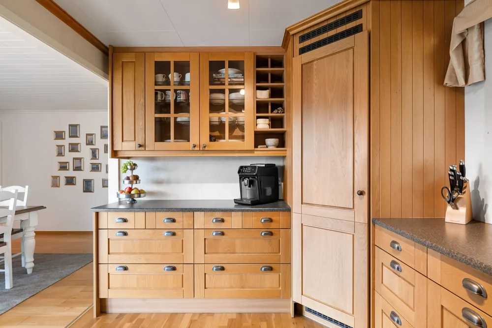 Illustrative domestic kitchen with natural oak cabinetry and a fitted work surface