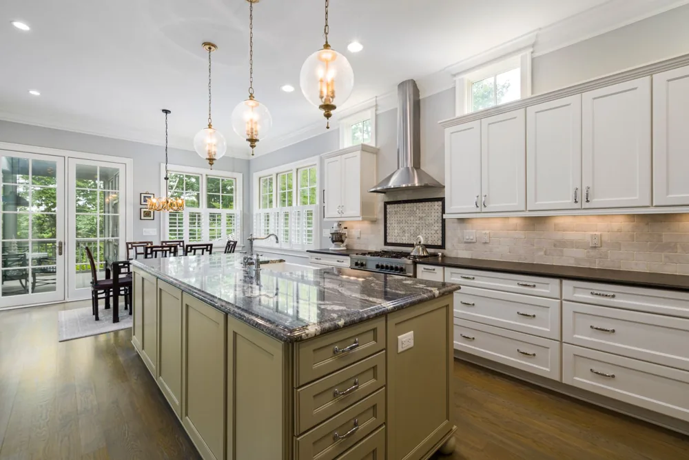 Illustrative kitchen with painted Shaker-style cabinets, a central island and natural wood flooring
